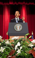 President Obama stands at a podium delivering a speech on "A New Beginning" at Cairo University on June 4, 2009