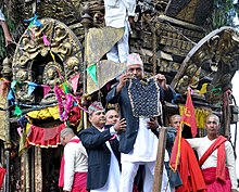 A Nepali man in Daura-Suruwal, coat and Dhaka topi, displays the bhoto during the Bhoto Jatra festival. Bhoto jatra.jpg