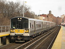 Flushing - Main Street LIRR station Bombardier M7 7799 enters Flushing.jpg