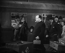 Still from The Lady Vanishes depicting Hitchcock