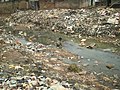 Child in open sewer in Nigeria