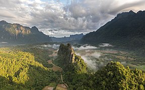 Green karst peaks seen from the top of Mount Nam Xay a sunny morning during the monsoon Vang Vieng Laos