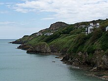 Coast of Howth with Tara Hall at the left where filming took place Howth cliff houses 2008.jpg