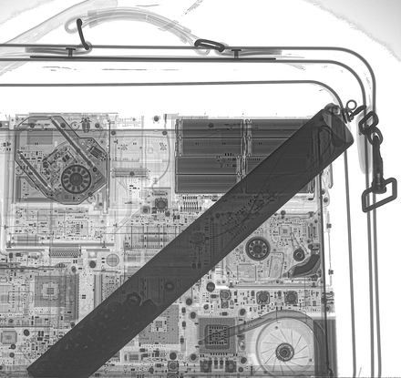 X-ray of a suitcase showing a pipe bomb and a laptop.