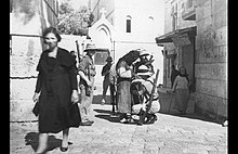 British soldiers frisk a Palestinian man in Jerusalem in the late 1930s, photo by Khalil Raad. Khalil Raad, British soldiers frisk a Palestinian man in Jerusalem, late 1930s.jpg