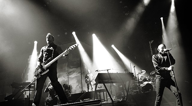 Linkin Park performing in Berlin, in October 2010. From left to right: Joe Hahn, Dave Farrell, Brad Delson, Mike Shinoda, Rob Bourdon and Chester Benn