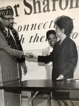 DC Mayor Sharon Pratt Kelly signed revised DC Barber Bill January 6, 1993. Pamela Ferrell in middle, and husband Uqdah, left, played instrumental roles in getting the Bill revised. Mayor Sharon Kelly signs Revised DC Barber Bill.png