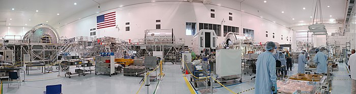 A panorama view of the high bay area in August 2010. Note the lights sometimes tend to change color from pink to gold hues. NASA SSPF factory panorama.jpg