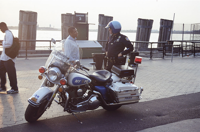 Motorcycle police officer speaks with a passerby