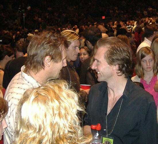 Leary behind Liam Neeson and Ralph Fiennes at a U2 concert in Madison Square Garden, October 2005