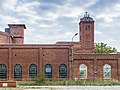 ehemalige Papierfabrik mit Werkhallen, Transformatorenhaus, Torhaus (Nr. 10), Drehscheibe für die Kleinbahn, Kanalbrücke und Werkswohngebäuden