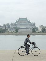 A man riding a bicycle along the Taedong River in Pyongyang, 2008 North Korea-Pyongyang-Grand Peoples Study House-01.jpg