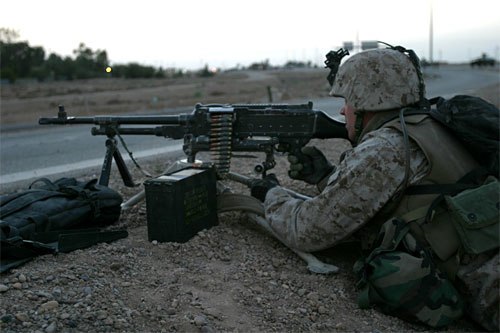 A U.S. Marine from the 1st Marine Division mans an M240G machine gun outside the Fallujah city limits in April 2004.