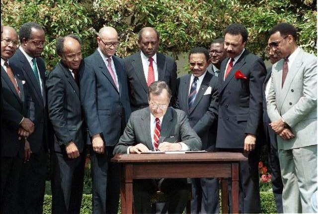 President George H. W. Bush signs a new Executive Order on historically black colleges and universities in the White House Rose Garden, April 1989