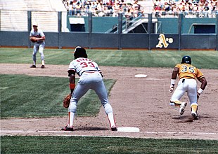 Rickey Henderson, shown here attempting to steal a base in 1983, is the MLB career leader in stolen bases. Rickey Henderson and Eddie Murray, 1983.jpg