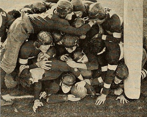 Harold Lloyd at the bottom of a pile on in the 1925 comedy film The Freshman, about a college student trying to become popular by joining the football