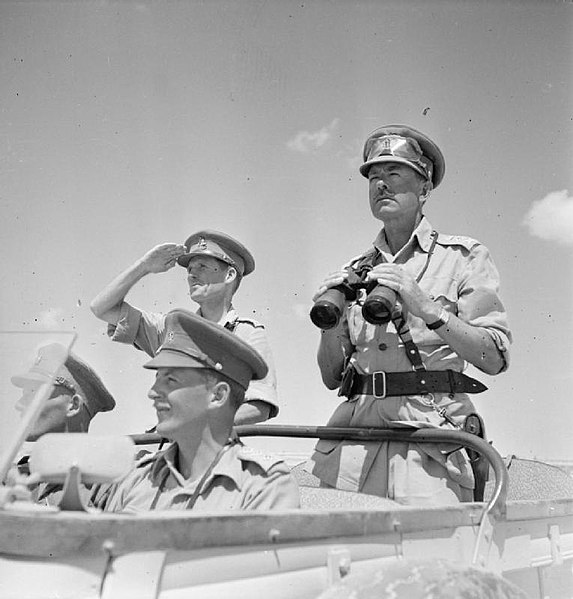 General Sir Harold Alexander, pictured here in August 1942 as Commander-in-Chief, Middle East, surveys the battlefront from an open car. To his right 