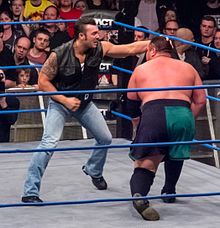 Bischoff as member of Aces & Eights, attacking Samoa Joe. This will not end well for Garrett.jpg