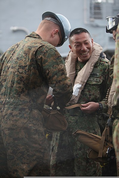 File:U.S. Marine Corps Lance Cpl. Windinhair Gilland, left, a combat cargo crewman with the amphibious assault ship USS Pearl Harbor (LSD 52), helps a Japanese soldier assigned to the Western Army Infantry Regiment 130208-M-OH054-089.jpg