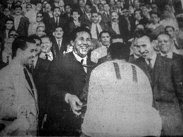 Ben Tifour, coach of the USM Alger receives from the hands of Ben Bella president, the first trophy Algerian football championship, under the gaze of 