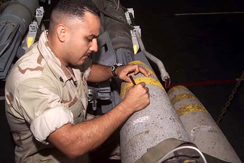 File:US Navy 011104-M-4912C-002 Service members sign weapons before deployment.jpg