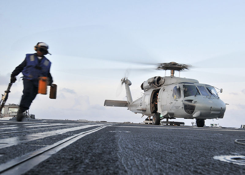 File:US Navy 090529-N-2638R-005 Boatswain's Mate Seaman Tiffany Walker, from New York, runs to a safe area after pulling the chocks and chains from a SH-60F Seahawk helicopter.jpg