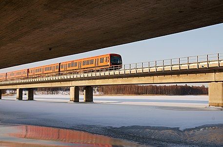 A Helsinki metro train crossing the Vuosaari metro bridge, between the stations of Rastila and Puotila.