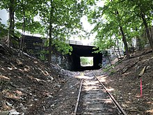 The Watertown-Cambridge Greenway right-of-way cleared of overgrowth in August 2018. Mt. Auburn Street passes overhead. Watertown Cambridge Greenway ROW cleared 818.agr.jpg