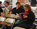 A woman awaiting Ralph Nader's campaign speech reading Nader's book Camera location 41° 33′ 12.96″ N, 73° 02′ 34.44″ W  View all coordinates using: OpenStreetMap