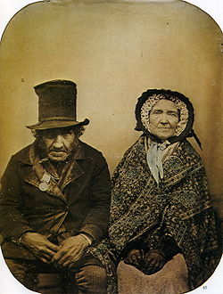 Ambrotype of an unknown English Peninsular War 1807-1814 veteran and his wife taken possibly 1860. His Military General Service Medal has six campaign clasps. 1860 Anonyme Un veteran et sa femme Ambrotype.jpg