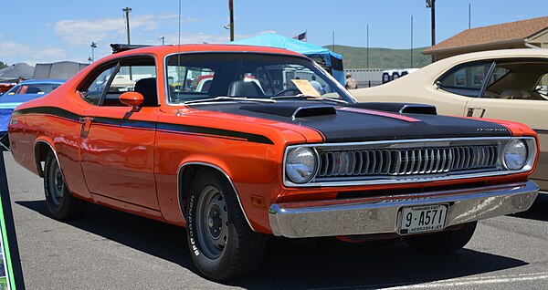 1971 Plymouth Duster Twister in Tor-Red EV2 Orange. Picture displays sharktooth grill, Twister hoodscoops and hood strobe stripe.