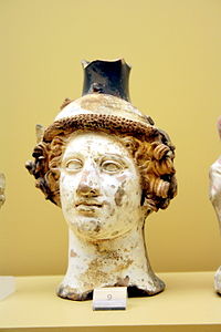 Terracotta vase in the shape of Dionysus' head, c. 410 BC; on display in the Ancient Agora Museum in Athens, housed in the Stoa of Attalus