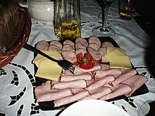 A platter of ham and cheese sliced for sandwiches