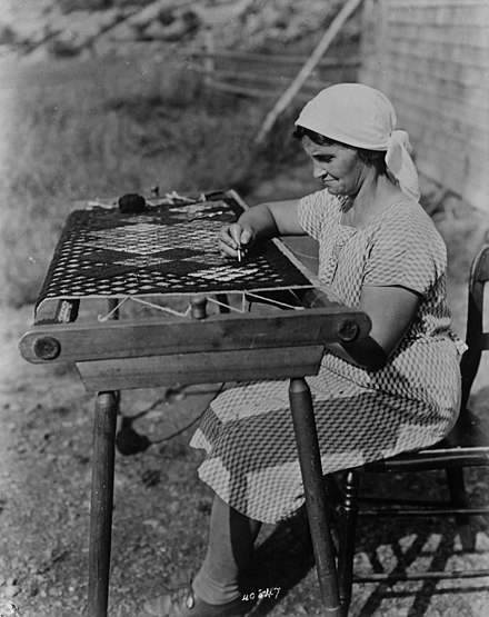 Acadian woman making a rug, 1938