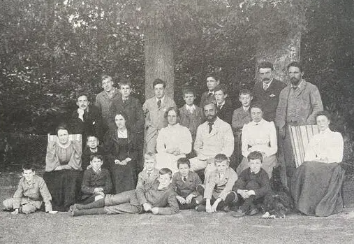  [[[:en:Amy Badley|(Mary) Amy Badley]] 1862-1956 suffragist and educationalist. Photo from Spartacus International. date unknown so guess 1900. Amy Badley to left of her husband John (in centre). Oswald Powell (right back row), Winifred Powell (seated left. Amys sister Elsie Garrett to right of John.Haden Badley