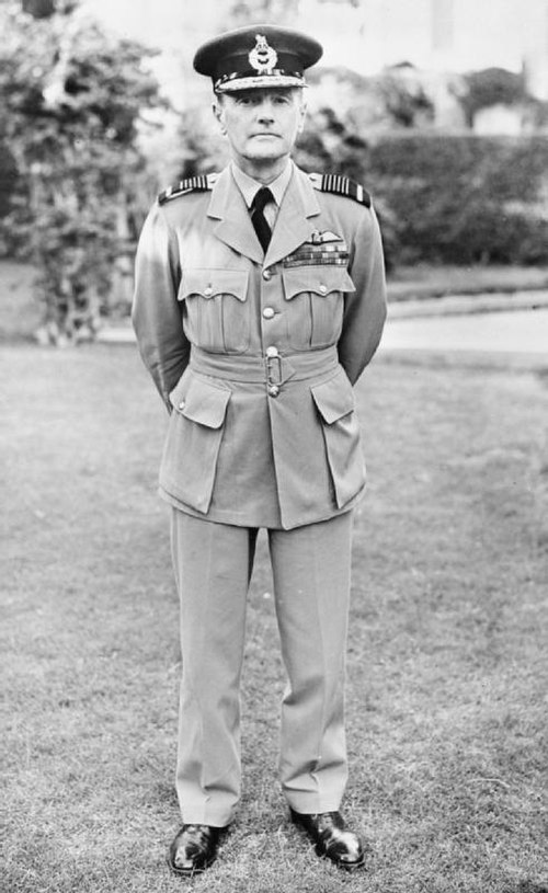 Air Chief Marshal Sir Arthur Longmore, Air Officer Commanding-in-Chief Middle East Command, standing in the gardens of Air Headquarters, Middle East C