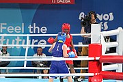 Deutsch: Boxen bei den Olympischen Jugendspielen 2018 Tag 12, 18. Oktober 2018 - Finale Fliegengewicht Mädchen – Martina La Piana (Italien, blau) schlägt Adijat Gbadamosi (Nigeria, rot) 5-0; Ringrichter ist James Beckles (Trinidad und Tobago). English: Boxing at the 2018 Summer Youth Olympics on 18 October 2018 – Girl's flyweight Gold Medal Bout - Martina La Piana (Italy, blue) beats Adijat Gbadamosi (Nigeria, red) 5-0; Referee is James Beckles (Trinidad and Tobago). Español: Boxeo en los Juegos Olímpicos Juveniles de Verano de 2018 en 18 de octubre de 2018 - Combate a medalla de oro de peso mosca para mujeres: Martina La Piana (Italia, azul) le gana a Adijat Gbadamosi (Nigeria, roja) 5-0; El árbitro es James Beckles (Trinidad y Tobago).