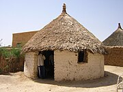 Earthen hut with thatched roof in Toteil, Sudan.