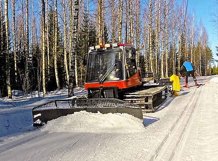 A snow groomer for cross-country trails with snow plow and attachments for the skate and classical lanes.