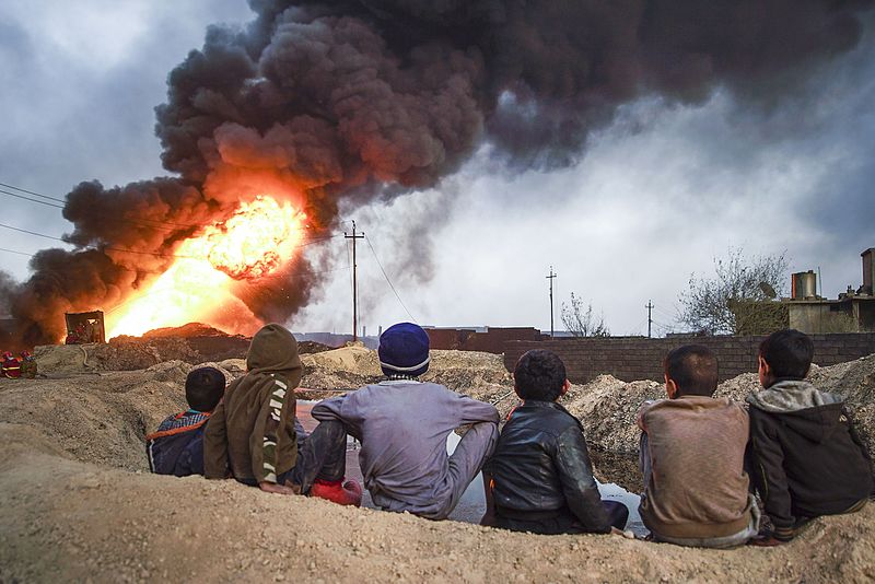 File:Local boys observing cityscape of Qayyarah town on fire.The Mosul District, Northern Iraq, Western Asia. 09 November, 2016.jpg