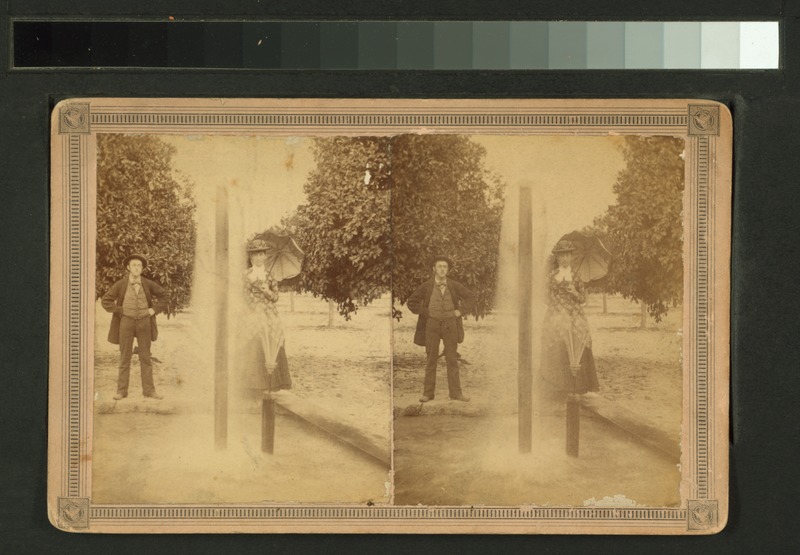 File:Man and woman, with parasol, standing behind double fountain (NYPL b11707411-G90F135 077ZF).tiff