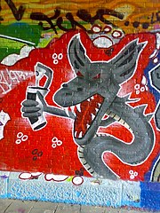 Piece van een slang die graffiti plaatst, aan de muur van de Nieuwe Roversbrug, een van de plekken in Katwijk waar het plaatsen van graffiti wordt toegestaan