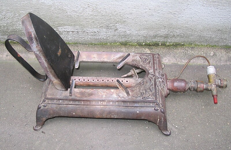 File:Old gas iron heater in a furrier's and headmaker's shop.jpg