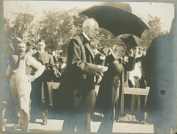 Goldwin Smith (center) and Andrew Dickson White (behind him, with top hat) at the opening of Goldwin Smith Hall, 1906.