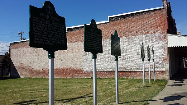 Historic markers in downtown Osceola detailing performances by notable musicians
