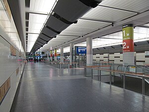 Large underground concourse with escalators and lifts down to platform level and up to ground level