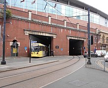 A tram entering Piccadilly from London Road. The tram station is located below the rail platforms in the undercroft. Piccadilly tram entrance from London Road.jpg