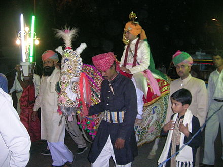 Bridegroom arrives on horseback at a Rajput wedding