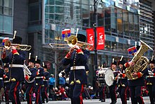 The RCA Band uniform, seen here with a member of the Band of the 15th Field Regiment, an affiliated reserve band with the RCA Band. Rogers Santa Claus Parade 2013 (11162882273).jpg