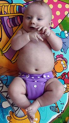 Baby wearing pocket diaper with snap closure Rotchi.jpg
